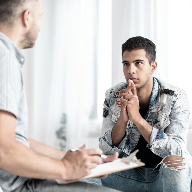 Teenaged male listening to his therapist